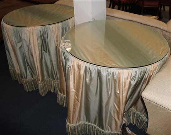 A pair of mahogany circular pedestal tables with silk covers and plate glass tops, 80cm wide